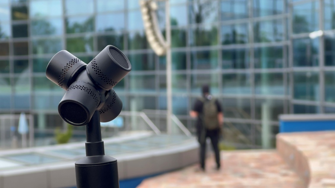 A microphone in front of a building

Description automatically generated