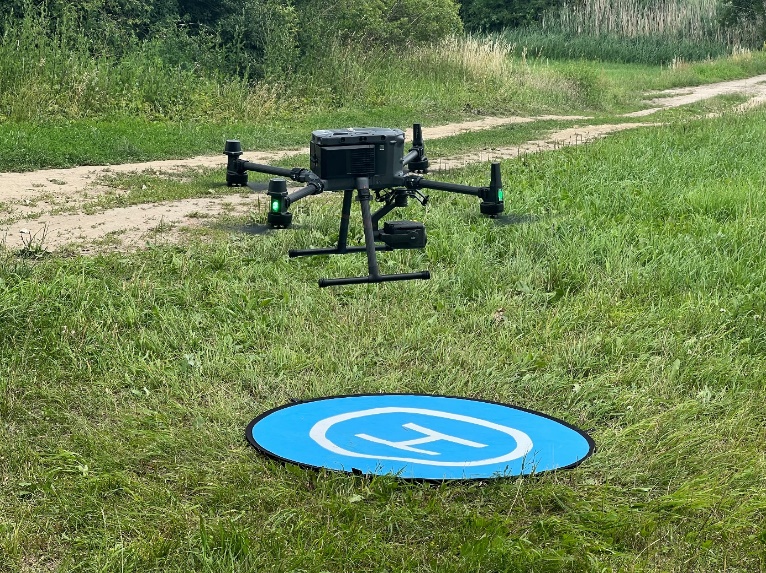 A drone on a grass field

Description automatically generated